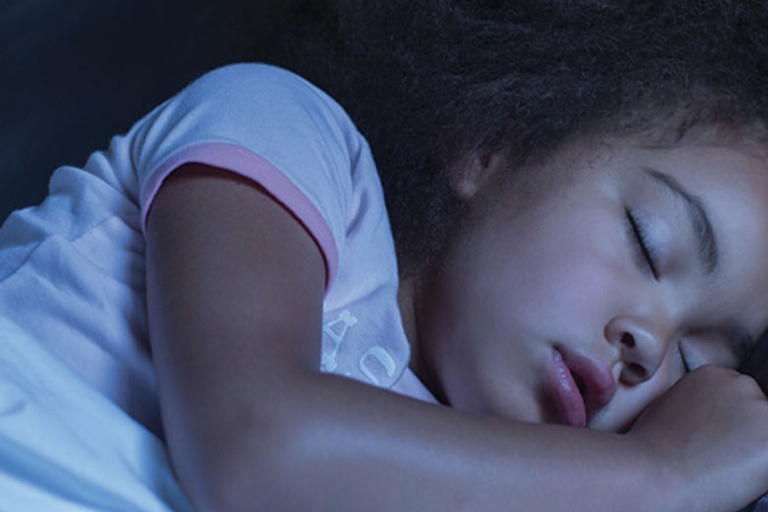 Young girl asleep in bed